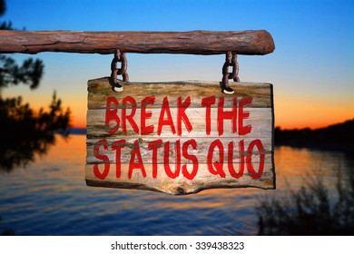 Break The Status Quo Motivational Phrase Sign On Old Wood With Blurred Background