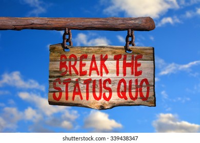 Break The Status Quo Motivational Phrase Sign On Old Wood With Blurred Background