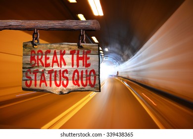 Break The Status Quo Motivational Phrase Sign On Old Wood With Blurred Background