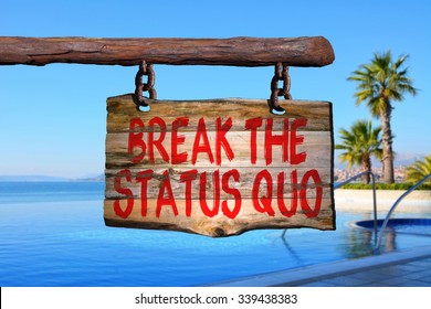 Break The Status Quo Motivational Phrase Sign On Old Wood With Blurred Background