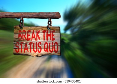 Break The Status Quo Motivational Phrase Sign On Old Wood With Blurred Background