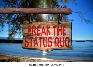 Break The Status Quo Motivational Phrase Sign On Old Wood With Blurred Background