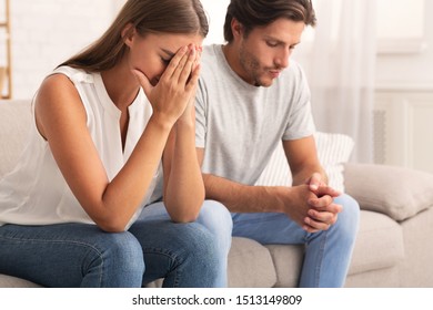 Break Up. Depressed Couple Sitting Together After Conversation About Futureless Relationship Indoor. Selective Focus