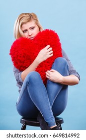 Break Up, Divorce, Bad Relationship Concept. Sad, Depressed Woman Holding Big Red Fluffy Pillow In Heart Shape, She Needs Love.