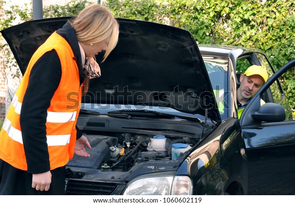 Breakdown\
assistance helps a woman repair her\
car