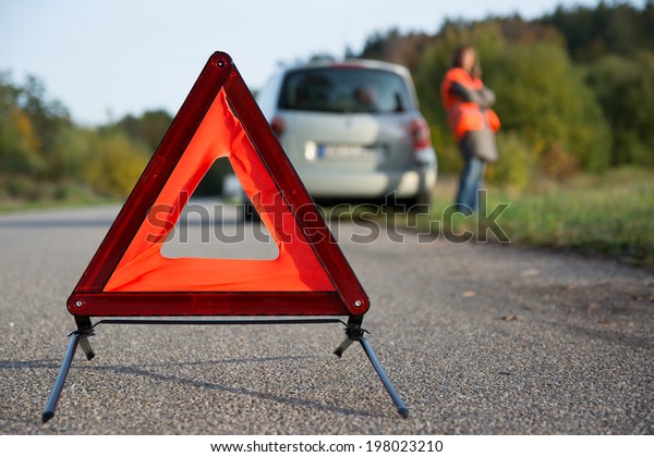 breakdown of car -\
arranging warning\
triangle
