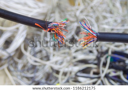  Breakdown of communication equipment. A damaged multi-core cable is shown close-up. Breakage of the telephone wire. Problems with telecommunications Internet connection. Disconnect.