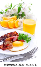 Breakfast With Bacon, Fried Egg And Orange Juice On White Isolated Background