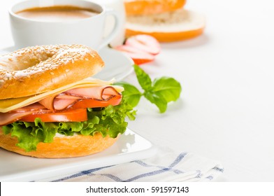 Breakfast of bagels with cheese and ham, salad and tomato close-up on white background - Powered by Shutterstock