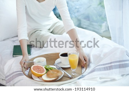 Similar – Image, Stock Photo Healthy breakfast on tray and couple lying in background