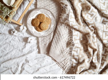 Breakfast In Bed Concept - Oatmeal Cookies. Warm, Soft, Light Colors, Warm Plaid, Cotton Flowers, Notepad In The Frame With Copy Spase. Flat Lay Style.