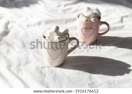Breakfast in bed for couples pastel flat lay composition with cups coffee and sweet marshmallow. Concept woman's or Valentine's Day. 