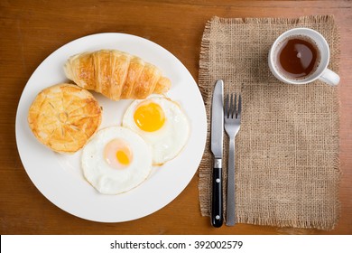 Breakfast Biscuit Croissant Egg Coffee On Teak Table Top View