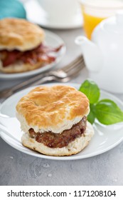 Breakfast Biscuits With Hot Sausage And Bacon Patty On White Plate