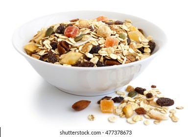 Breakfast bowl of fruit and nut muesli on white. Spilled muesli. - Shutterstock ID 477378673