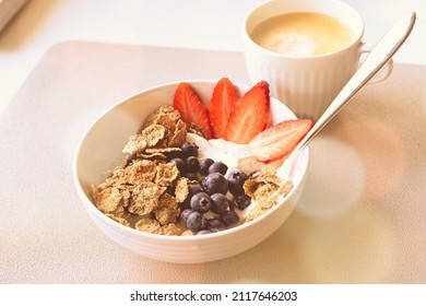 Breakfast Bowl With Greek Yoghurt, Blueberries, Strawberries And Full Corn Flakes. A Cup Of Coffee To Charge The Day.