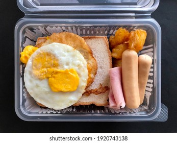 Breakfast Box Set With Fried Egg, Slice Bread, Fried Potato, Ham And Sausage. Homemade Breakfast Bento In Morning Time And Delivery Menu. 