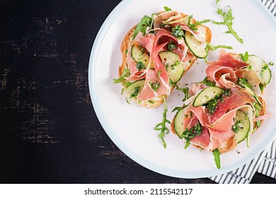 Breakfast Or Brunch.  Open Sandwich With Prosciutto Or Jamon On White Plate. Mediterranean Appetizer. Top View, Overhead