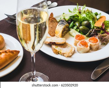 Breakfast Or Brunch With Sparkling Wine In A Fancy Hotel Or Restaurant. Crepes With Caviar, Greens And Other Food. Mini Pies And Variety Of Crepes On A Background.