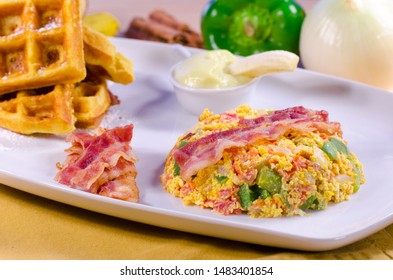 Breakfast Brunch Table With Scrambled Eggs, Veggies, Bacon, Waffles, Banana Pudding, Orange Juice, Waffles On White Plate. Restaurant Style. 