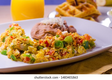 Breakfast Brunch Table With Scrambled Eggs, Veggies, Bacon, Waffles, Banana Pudding, Orange Juice, Waffles On White Plate. Restaurant Style. 