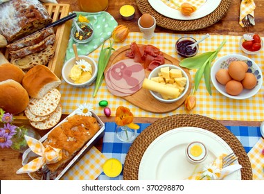 Breakfast Or Brunch Table Setting Full Of Healthy Ingredients For A Delicious Easter Meal With Friends And Family Around The Table  
