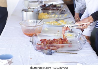 Breakfast buffet being served with bacon