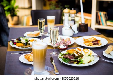 Breakfast Buffet Concept, Breakfast Time in Luxury Hotel, Brunch with Family in Restaurant, Glass of Champagne with Tasty Food on a Plates