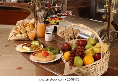 breakfast buffet with eggs, waffles, fruit and coffee