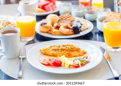 Breakfast Buffet in Luxury Hotel, Omelette and Fresh Desserts, Buns, Croissant. Dining Table with Plate of Delicious Food. Food in Hotel with Plates Full of Food, Orange Juice in Glass and Coffee Cups