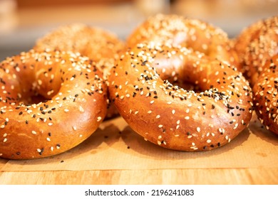 Breakfast Buns Or Dough Nuts With Sesame Seeds On Top. Bakery Food Display For Customers In A Coffee Shop.