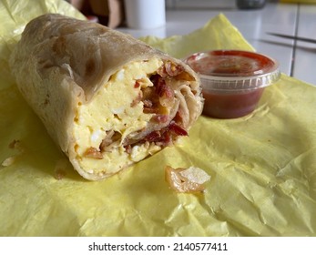 Breakfast Burrito And Salsa In Yellow Wrapper