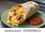 Breakfast Burrito: A warm tortilla stuffed with scrambled eggs, cheese, sausage or bacon, and potatoes, wrapped tightly.