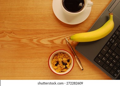 Breakfast At A Busy Worker's Desk Or Home Office. Flexible Working Parents Awareness Day.