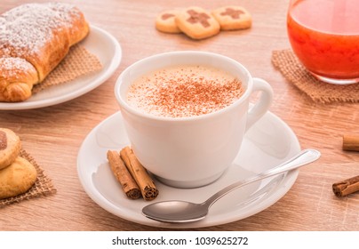 breakfast, cappuccino cup with biscuits and cookies , orange juice 