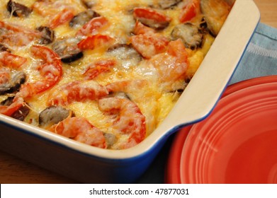 Breakfast Casserole With Eggs, Sausage, Tomatoes, Potatoes, Onion And Cheese