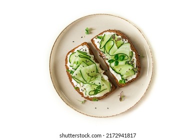 Breakfast, cereal bread sandwiches, cream cheese, sliced cucumber, with micro greenery on a light table, close-up, top view, selective focus, no people, - Shutterstock ID 2172941817