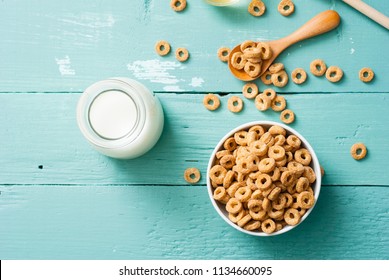 breakfast cereal with milk, honey on blue wood table
