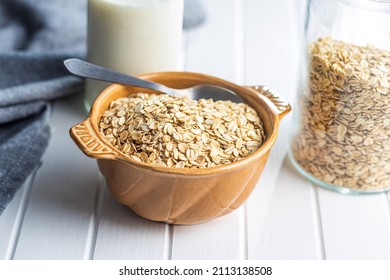 Breakfast cereals. Uncooked oatmeal. Raw oat flakes in bowl.