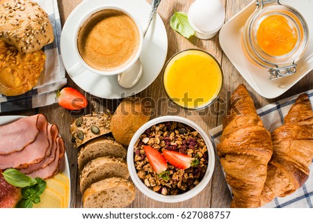 breakfast of coffee, juice, muesli, breads, ham and cheese - top view
