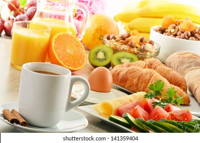 Breakfast with coffee, orange juice, croissant, egg, vegetables and fruits - Powered by Shutterstock