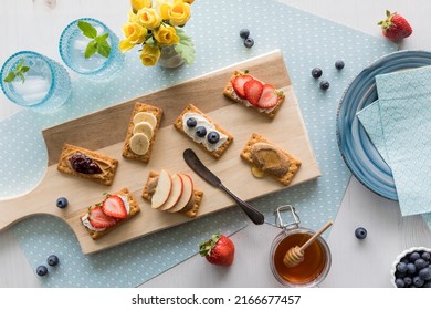 Breakfast crackers topped with fresh fruit, nut butter or cream cheese spread. - Powered by Shutterstock