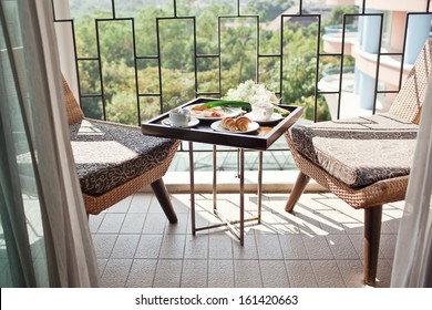 Breakfast With Cup Of Black Coffee, Eggs And Croissants On Balcony