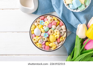 Breakfast easter bunny trail mix. Mixed colorful breakfast cereals and flakes, with chocolate eggs, marshmallow, sugar sprinkles, snacks. Sweets homemade kids Easter morning treats, with milk jug - Powered by Shutterstock