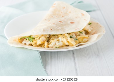 Breakfast Egg Burrito With Cheese,  Herbs And Spices On White Plate