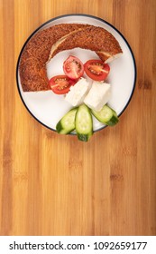 Breakfast with feta cheese,  simit, cucumber, and cherry tomoto  isolated on wooden background top view - Shutterstock ID 1092659177