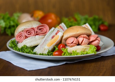 Breakfast Fresh Healthy Sandwich And Burger Appetizing With Bread, Egg, Tomatoes, Onion, Roll Ham, Vegetable, Bacon, Cheese,  Sausage On Wooden Background Variety