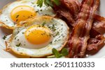 Breakfast with fried eggs and bacon close up. Fried sunny side eggs with bacon on plate, healthy keto meal.
