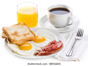 breakfast with  fried eggs, toasts, juice and coffee