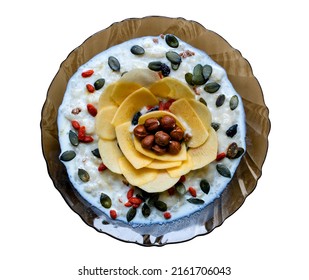 Breakfast, Healthy Food, Porridge With Nuts, Seeds And Dried Fruits In A Plate On A Wooden Table.